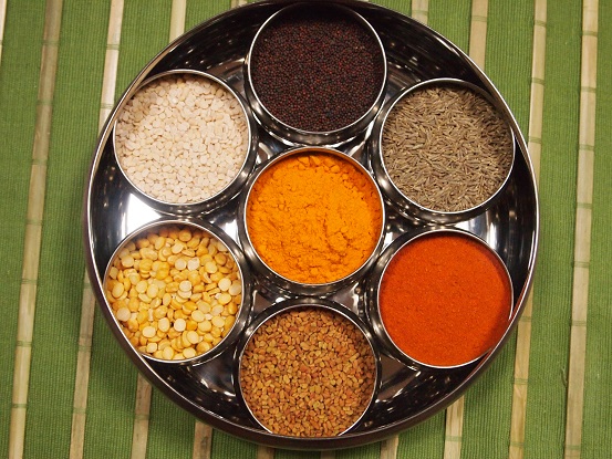 The spice box — a round steel box with separate containers for each of the spices — is the best way to store the dry spices. The spices most commonly stored in this box are mustard seeds, cumin seeds, fenugreek seeds, chili powder, whole red chilies and turmeric, and the yellow and white lentils used in small quantities in curries and rice dishes — urad dal (black gram dal), channa dal (Bengal gram dal). Asafetida is almost always stored in its own container so as to preserve its intense flavor and aroma.