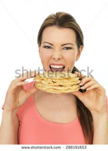 stock-photo-attractive-happy-young-woman-eating-a-pile-of-indian-style-poppadoms-286191653