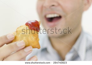stock-photo-close-up-of-traditional-indian-stuffed-patties-known-as-samosa-with-ketchup-sauce-on-it-about-to-284740823