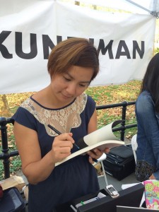 Cathy Linh Che of Kundiman signing her book.